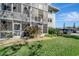 Building exterior with lush landscaping and parking at 649 Tamiami S Trl # 107, Venice, FL 34285