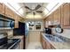 Modern kitchen featuring stainless steel appliances and ceiling fan at 649 Tamiami S Trl # 107, Venice, FL 34285
