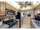 Kitchen with wood cabinets, granite counters, and appliances at 649 Tamiami S Trl # 107, Venice, FL 34285