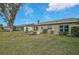 Landscaped backyard with grassy area and privacy at 652 Linden Dr, Englewood, FL 34223