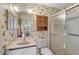 Updated bathroom with walk-in shower and built-in storage at 652 Linden Dr, Englewood, FL 34223