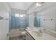Bathroom with light blue tile, vanity, and shower/tub combo at 652 Linden Dr, Englewood, FL 34223