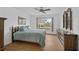Bedroom with wood floors, ceiling fan, and view of backyard at 652 Linden Dr, Englewood, FL 34223