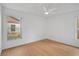Simple bedroom with light wood floors and a ceiling fan at 652 Linden Dr, Englewood, FL 34223