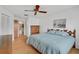 Spacious bedroom with light wood floors and ceiling fan at 652 Linden Dr, Englewood, FL 34223