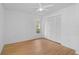 Bright bedroom with light wood floors and double door closet at 652 Linden Dr, Englewood, FL 34223