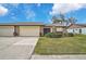 Attractive exterior with two-car garage and manicured lawn at 652 Linden Dr, Englewood, FL 34223