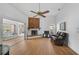 Bright living room featuring a fireplace, sliding glass doors, and hardwood floors at 652 Linden Dr, Englewood, FL 34223