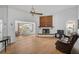 Bright living room featuring a fireplace, sliding glass doors, and hardwood floors at 652 Linden Dr, Englewood, FL 34223