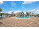 Community pool and clubhouse with lounge chairs and patio at 652 Linden Dr, Englewood, FL 34223
