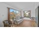 Sunroom with a light beige couch, wicker chairs, and large windows at 652 Linden Dr, Englewood, FL 34223