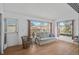 Sunroom with a light beige couch, wicker chairs, and large windows at 652 Linden Dr, Englewood, FL 34223