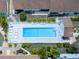 Community pool with surrounding patio and lounge chairs at 6796 Gasparilla Pines Blvd # 13, Englewood, FL 34224
