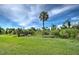 Large backyard with mature trees at 6796 Gasparilla Pines Blvd # 13, Englewood, FL 34224