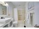 Clean bathroom with white vanity, tub, and shower at 6796 Gasparilla Pines Blvd # 13, Englewood, FL 34224