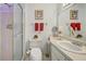 Clean bathroom with shower stall, vanity, and plenty of storage at 6796 Gasparilla Pines Blvd # 13, Englewood, FL 34224