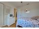 Bedroom with seashell bedding, white dresser, and wood floors at 6796 Gasparilla Pines Blvd # 13, Englewood, FL 34224