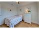 Guest bedroom with seashell bedding and white wicker dresser at 6796 Gasparilla Pines Blvd # 13, Englewood, FL 34224
