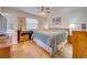 Spacious bedroom with light oak flooring and ceiling fan at 6796 Gasparilla Pines Blvd # 13, Englewood, FL 34224