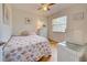 Cozy bedroom with seashell bedding and light wood floors at 6796 Gasparilla Pines Blvd # 13, Englewood, FL 34224