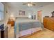 Bright bedroom featuring hardwood floors and ceiling fan at 6796 Gasparilla Pines Blvd # 13, Englewood, FL 34224