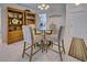 Dining area with glass table and four chairs at 6796 Gasparilla Pines Blvd # 13, Englewood, FL 34224