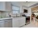 Updated kitchen, featuring stainless steel appliances and white cabinetry at 6796 Gasparilla Pines Blvd # 13, Englewood, FL 34224