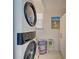 Bright laundry room with stackable washer and dryer at 6796 Gasparilla Pines Blvd # 13, Englewood, FL 34224