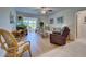 Living room with hardwood floors, comfy seating and large windows at 6796 Gasparilla Pines Blvd # 13, Englewood, FL 34224