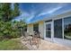 Relaxing patio with seating area and grill at 6796 Gasparilla Pines Blvd # 13, Englewood, FL 34224