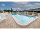 Inviting community pool with plenty of lounge chairs at 6796 Gasparilla Pines Blvd # 13, Englewood, FL 34224