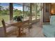 Bright sunroom with garden views, table and chairs, and comfy seating at 6796 Gasparilla Pines Blvd # 13, Englewood, FL 34224