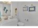 Small bathroom with white vanity and nautical decor at 738 Sorrento Inlt # 738, Nokomis, FL 34275