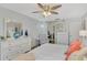 Main bedroom with king bed, dresser, and access to the bathroom and office at 738 Sorrento Inlt # 738, Nokomis, FL 34275