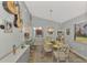 Charming dining room with glass table and six chairs at 738 Sorrento Inlt # 738, Nokomis, FL 34275
