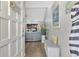 Bright and airy entryway with bench and view to living room at 738 Sorrento Inlt # 738, Nokomis, FL 34275