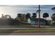 Detached teal garage with overgrown landscaping at 810 Texas St, Englewood, FL 34223