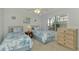 Twin bedroom with two beds, nightstand and dresser at 817 Montrose Dr # 103, Venice, FL 34293