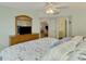 Main bedroom with king bed, dresser, and views to living room at 817 Montrose Dr # 103, Venice, FL 34293