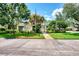 Community clubhouse with a flag and lush landscaping at 817 Montrose Dr # 103, Venice, FL 34293