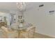 Dining area with glass top table and wicker chairs at 817 Montrose Dr # 103, Venice, FL 34293