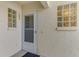 Condo entry with white door and glass block windows at 817 Montrose Dr # 103, Venice, FL 34293