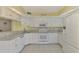 Modern kitchen with white cabinets and granite countertops at 817 Montrose Dr # 103, Venice, FL 34293