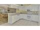 Bright kitchen with white cabinets and a breakfast bar at 817 Montrose Dr # 103, Venice, FL 34293