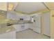 Well-equipped kitchen featuring white cabinets and granite countertops at 817 Montrose Dr # 103, Venice, FL 34293