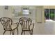 Kitchen with breakfast bar and white cabinets at 817 Montrose Dr # 103, Venice, FL 34293