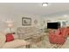 Living room with neutral tones and a large mirror at 817 Montrose Dr # 103, Venice, FL 34293