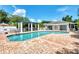 Community pool with lounge chairs and a covered seating area at 817 Montrose Dr # 103, Venice, FL 34293
