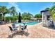 Community pool with lounge chairs, tables, and umbrellas at 817 Montrose Dr # 103, Venice, FL 34293