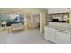 Cozy sunroom with wicker furniture and access to backyard at 817 Montrose Dr # 103, Venice, FL 34293
